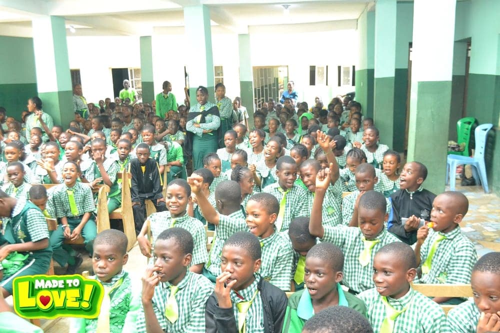 Students in green checked uniforms gathered for a Love & Light Foundation school outreach